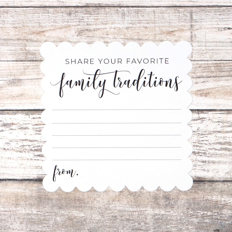 May include: White card with scalloped edges and the text "Share your favorite family traditions" printed in black. There is a blank space below the text for writing and the word "from." printed at the bottom.
