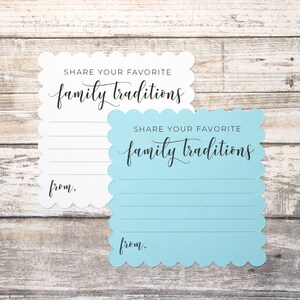May include: Two white and blue cards with scalloped edges. The cards have the text "Share your favorite family traditions" and a line for writing "from."
