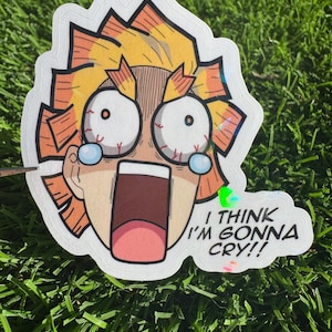 Pode incluir: Um adesivo com um personagem de anime com uma expressão angustiada, olhos arregalados e boca aberta. O personagem tem cabelo amarelo e laranja. O texto no adesivo diz: "I THINK I'M GONNA CRY!!"