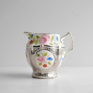 Puede incluir: Un juego de tres tazas de cerámica con un acabado moteado y mate. Las tazas son de color crema, gris claro y gris oscuro. Cada taza tiene un diseño simple y minimalista.