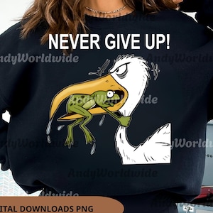 May include: Black sweatshirt with the text "NEVER GIVE UP!" and a cartoon illustration of a pelican trying to eat a frog. The image also includes the text "DIGITAL DOWNLOADS PNG" and a 70% off promotion.