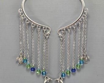 Pendientes tipo ear cuff con diseño de delfín y tortuga marina, cristales de colores oceánicos, sin necesidad de perforación (par o individual).