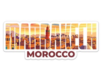 May include: A sticker featuring the word "MARRAKECH" in a white, blocky font, with a cityscape visible through the letters. The word "MOROCCO" is below in a maroon font. The image shows a sunset over the city.