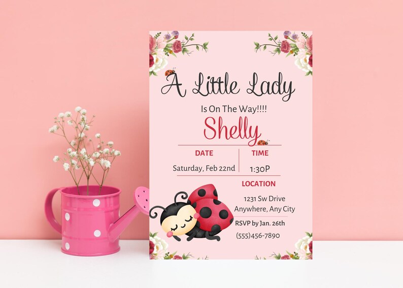 May include: Pink baby shower invitation with floral accents and ladybug illustrations. The invitation reads "A Little Lady Is On The Way!!!! Shelly" with date, time, and location details. A pink watering can with white polka dots and flowers is on the left.