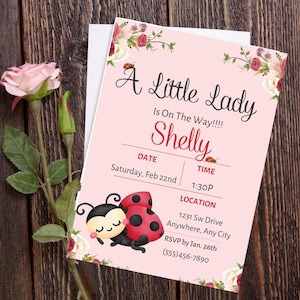 May include: A pink baby shower invitation with floral accents and ladybug illustrations. The invitation reads "A Little Lady Is On The Way!!!! Shelly" with event details. A pink rose and greenery are on a wooden background.