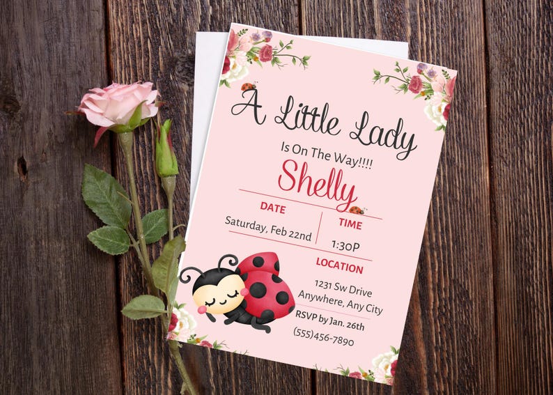 May include: A pink baby shower invitation with floral accents and ladybug illustrations. The invitation reads "A Little Lady Is On The Way!!!! Shelly" with event details. A pink rose and greenery are on a wooden background.
