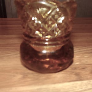May include: Amber glass candle holder shaped like a shoe with a diamond pattern.