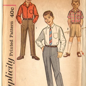 May include: A vintage Simplicity sewing pattern for boys' clothing. The pattern is for a shirt and trousers, and includes three different styles. The pattern number is 3610 and the size is 6. The pattern is printed on a light brown paper with a pink border.