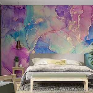 May include: A bedroom featuring a bed and a bedside table. The wall behind the bed is adorned with a large abstract painting in shades of purple, blue, and gold.