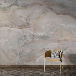 May include: A yellow chair with a black and white checked cushion sits in front of a wall with a light grey and brown marble pattern.