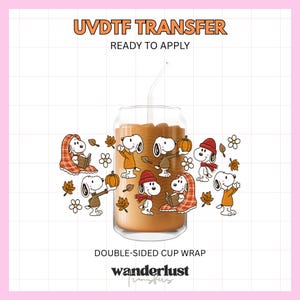 May include: A UVDTF transfer ready to apply, featuring a double-sided cup wrap design with Snoopy characters in autumn attire, holding pumpkins, reading books, and surrounded by fall leaves and flowers on a clear glass cup with a straw.