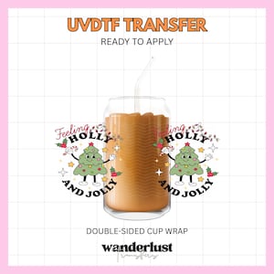 May include: A UVDTF transfer double-sided cup wrap featuring a cartoon Christmas tree with arms and legs, holding a candy cane. The text reads Feeling HOLLY AND JOLLY. The design includes holly berries, stars, and string lights on a glass cup.