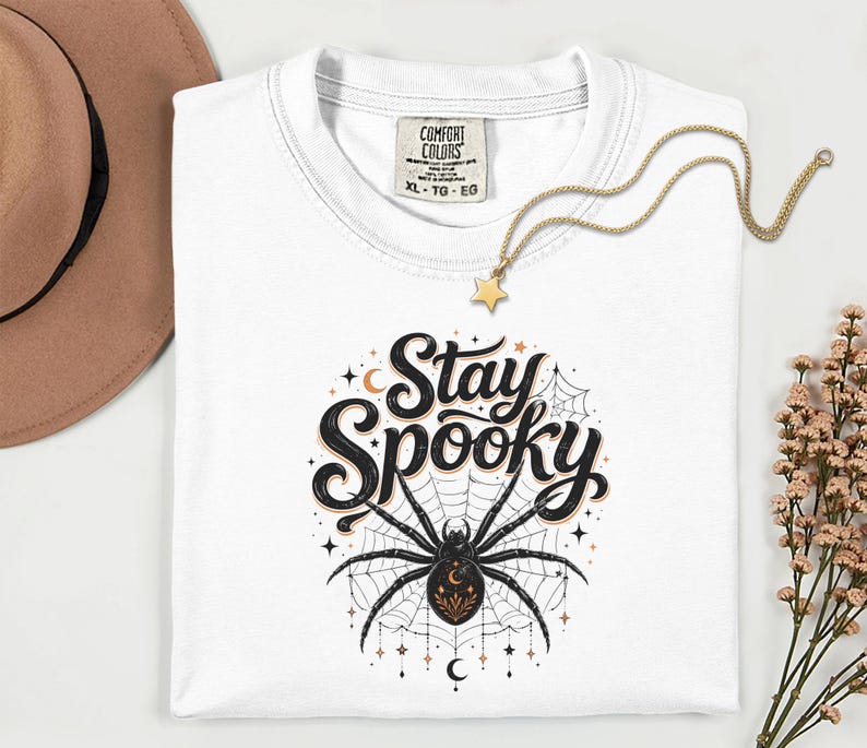 White t-shirt with "Stay Spooky" text and a spider graphic.