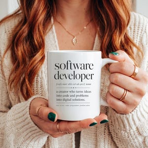 White mug with "software developer" definition and related terms.