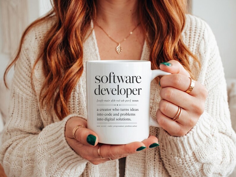 White mug with "software developer" definition and related terms.