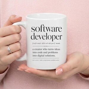 White mug with "software developer" definition and related terms.
