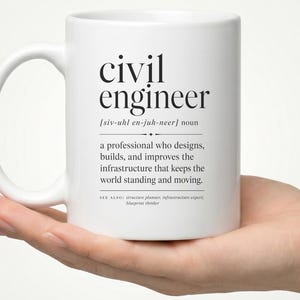 May include: A white ceramic mug featuring black printed text that defines the term civil engineer. The text includes the phonetic pronunciation, the noun classification, and a description of the profession, followed by related terms.