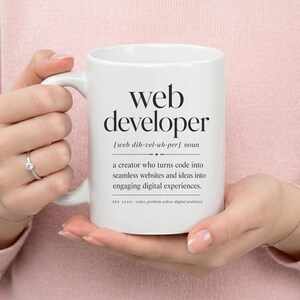 White mug with "web developer" definition and related terms.