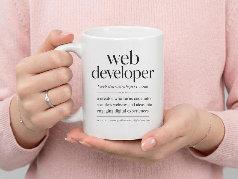 White mug with "web developer" definition and related terms.