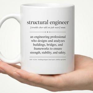 May include: A white ceramic mug featuring black printed text that defines the term structural engineer. The text includes a phonetic pronunciation, a noun classification, and a description of the profession, followed by a see also section.