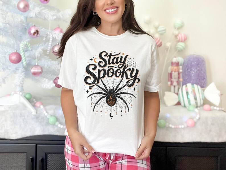 White t-shirt with "Stay Spooky" text and a large spider graphic.