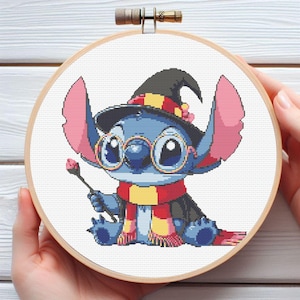 May include: Cross-stitch embroidery of Stitch from Lilo & Stitch, dressed as a wizard. The blue alien is wearing a black hat with red and yellow stripes, round glasses, and a red and yellow scarf. He holds a wand in his hand.