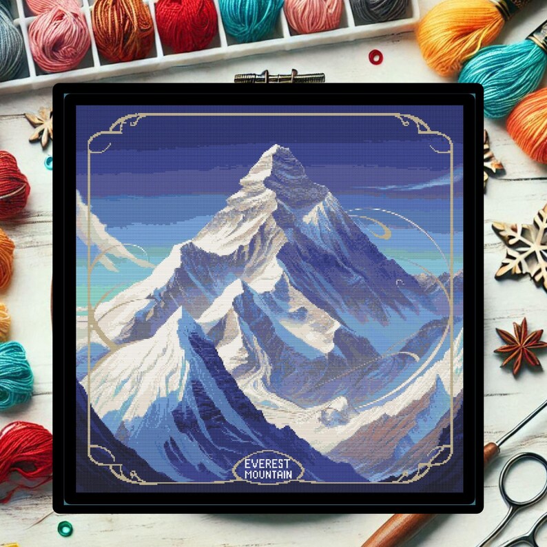 May include: A cross-stitch pattern of Mount Everest, a snow-capped mountain range with a blue sky and white clouds. The text "EVEREST MOUNTAIN" is at the bottom of the image.