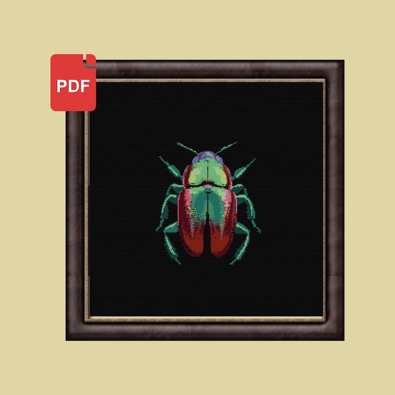 May include: A cross-stitch pattern featuring a colorful beetle with red, green, and blue accents on a black background. The pattern is framed in a dark brown frame.