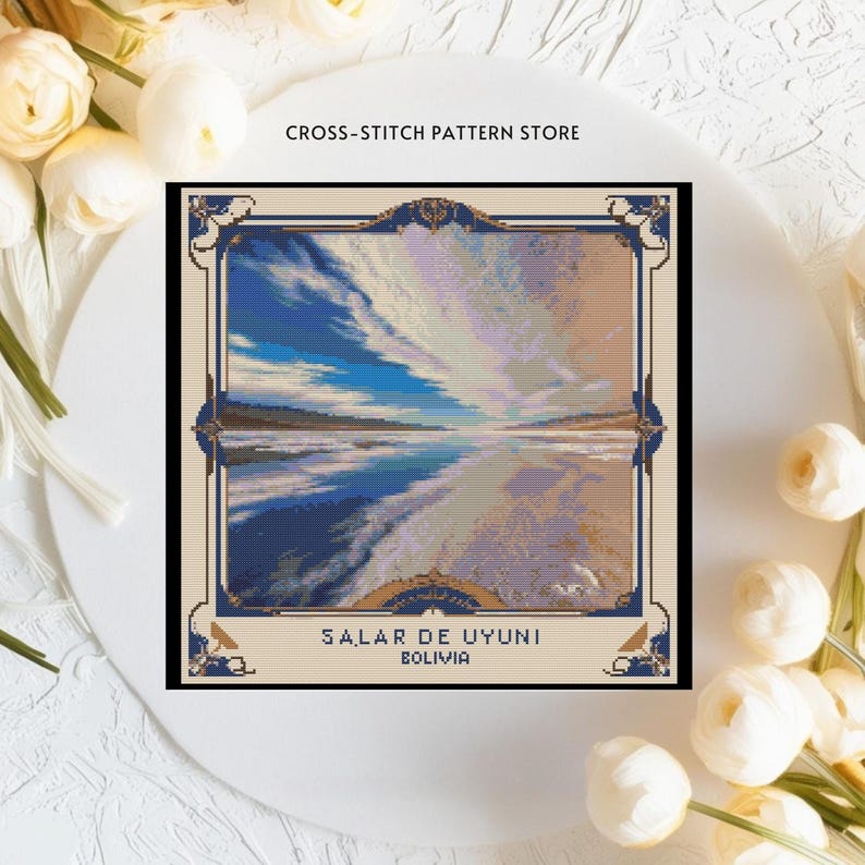 May include: Cross-stitch pattern depicting a scenic landscape with a blue sky, white clouds, and a body of water reflecting the sky. The text "SALAR DE UYUNI BOLIVIA" is at the bottom of the image.
