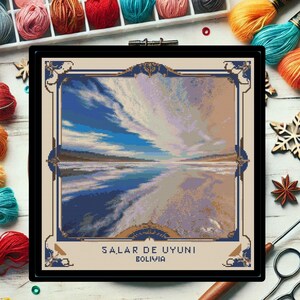 May include: A cross-stitch pattern depicting a scenic landscape with a blue sky, white clouds, and a reflective body of water. The text "SALAR DE UYUNI BOLIVIA" is at the bottom of the image.