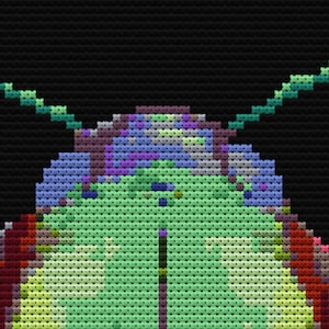 May include: A close-up of a green, blue, and purple pixelated design. The design is reminiscent of a flower or a butterfly.
