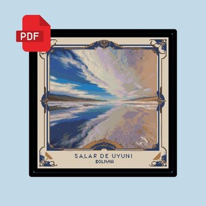 May include: A framed cross-stitch pattern of a landscape scene with a blue sky, white clouds, and a body of water. The text "SALAR DE UYUNI BOLIVIA" is at the bottom of the image.