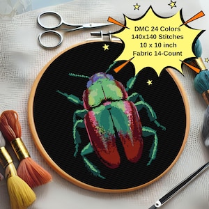 May include: A cross-stitch pattern of a colorful beetle on a black background, framed in a wooden hoop. The pattern uses 24 DMC colors and is 140 x 140 stitches, measuring 10 x 10 inches. The fabric is 14-count.