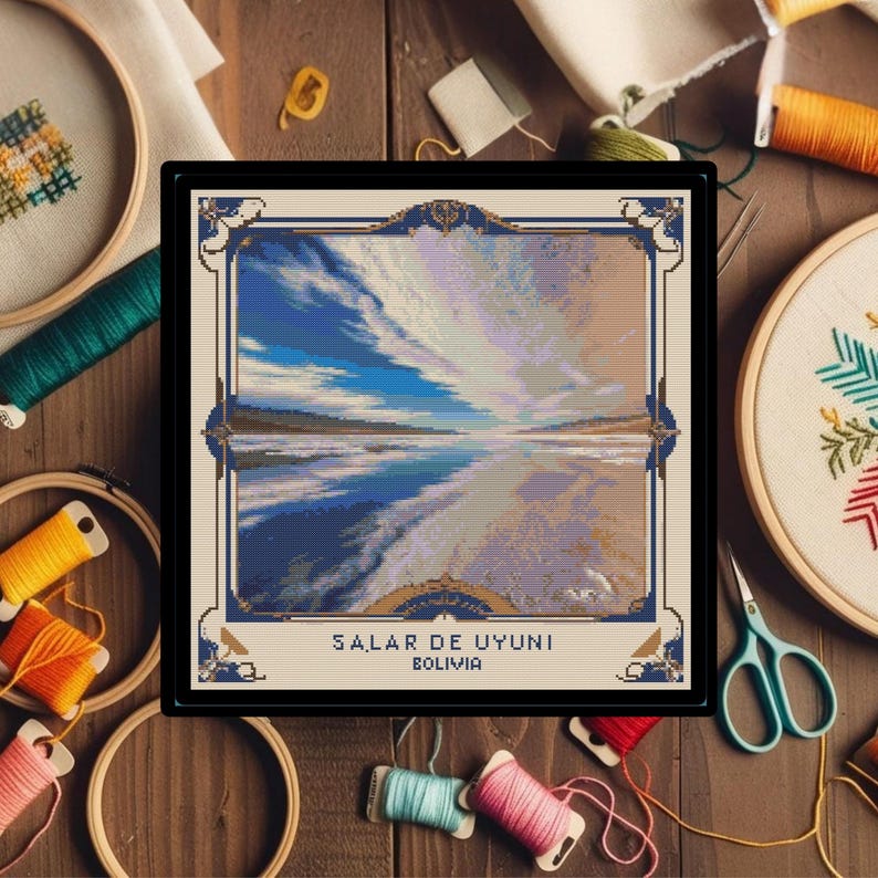 May include: Cross-stitch pattern depicting a scenic landscape with a blue sky, white clouds, and a reflective body of water. The pattern is framed with a gold border and includes the text "SALAR DE UYUNI BOLIVIA".