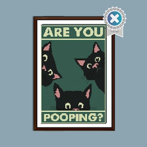 May include: A framed print with a green background and three black cats with pink ears. The text "ARE YOU POOPING?" is displayed in white block letters. The artwork has a brown frame.