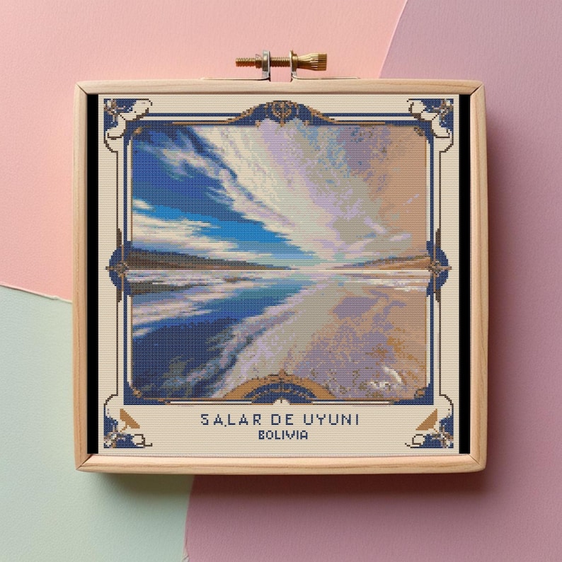 May include: A framed cross-stitch artwork depicting a scenic view of Salar de Uyuni, Bolivia. The image features a vast, white salt flat with a blue sky and clouds reflected in the water.