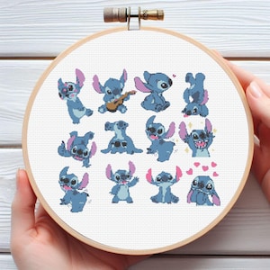 Può includere: Un telaio da ricamo a punto croce con un personaggio dei cartoni animati blu in varie pose. Il personaggio ha grandi orecchie ed è circondato da un telaio di legno. Lo sfondo è bianco.