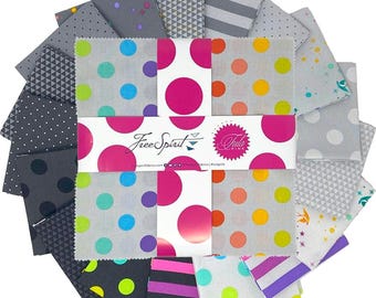 May include: A collection of fabric squares in various patterns and colors. The squares feature polka dots, stripes, and geometric designs in shades of pink, gray, black, and white. The fabric is arranged in a circular pattern, with a central label that reads "Free Spirit".