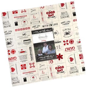 May include: A white fabric with a red and black pattern featuring various sewing and quilting related phrases and images. The fabric has a vintage feel and includes phrases like "It's a good day for a quilt", "Make life sweet", "Sewing heals the soul", and "Handmade with love".