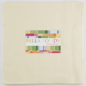 May include: A cream-colored fabric square with a label that reads "Bella Solids moda" in colorful letters.