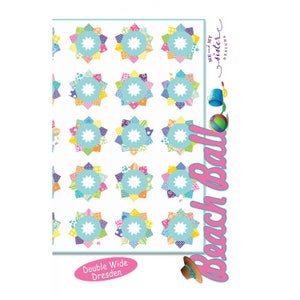 May include: A sheet of 20 colorful double-wide Dresden quilt blocks with a white center circle. The blocks are arranged in four rows of five. The text "Beach Ball" is written vertically in pink with a beach ball and a bucket and shovel. The text "Double Wide Dresden" is written below the blocks.