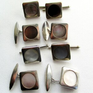 May include: Set of six silver cufflinks with round mother-of-pearl inlays. Each cufflink has a square frame.