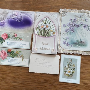 May include: A collection of vintage Easter greeting cards. The cards feature floral designs, religious imagery, and pastel colors. Some cards have embossed details and handwritten text, including the phrases "Happy Easter" and "Easter Salutation."
