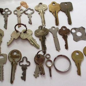 May include: A collection of vintage keys, some with decorative designs, including a key with the text "LSDA" and another with the text "DURRELL".