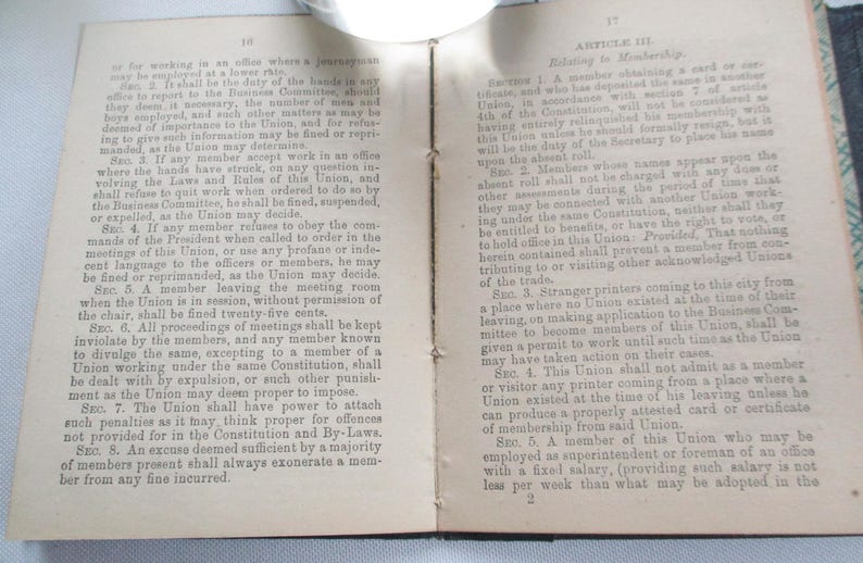 May include: An open book with aged, yellowed pages. Text is visible on both sides, with headings and numbered sections. The left page has the number 10 at the top. The right page has the number 17 at the top.