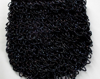 May include: A black beaded bag with a velvet top. The bag is made of small, iridescent beads that are woven together in a pattern.