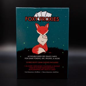 May include: A teal blue box with a red fox illustration holding a heart-shaped note. The box contains 45 double-sided dry erase cards for game tokens, art, proxies, and more. 10 clear sleeves are included. One in every 1000 boxes contains a unique hand-drawn and autographed art sketch card. Card dimensions: 63x88mm. Sleeve dimensions: 64x89mm.