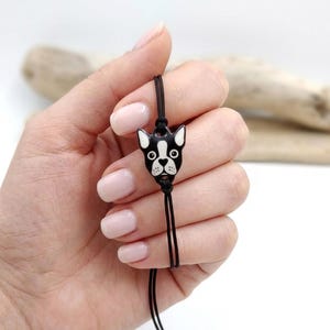 Person holding a minimalist Boston Terrier dog bracelet. Unique pet lover gift for her, featuring a dainty handmade animal charm.