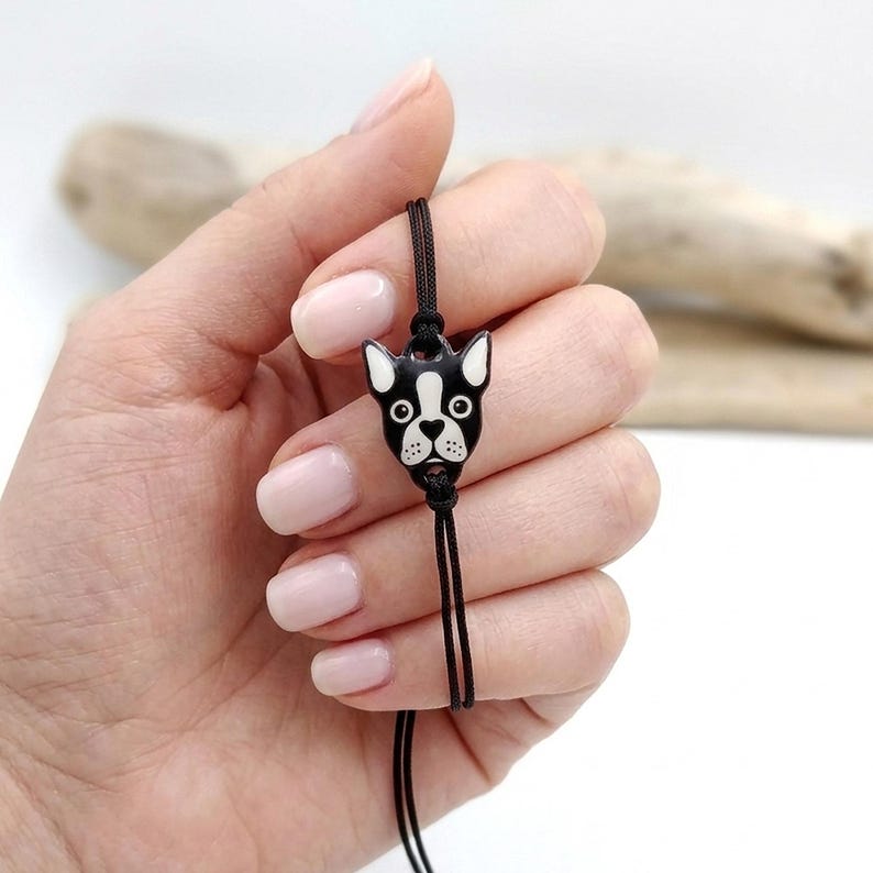 Person holding a minimalist Boston Terrier dog bracelet. Unique pet lover gift for her, featuring a dainty handmade animal charm.
