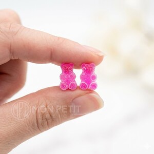 Handmade sugar gummy bears earrings shown on fingers to display size